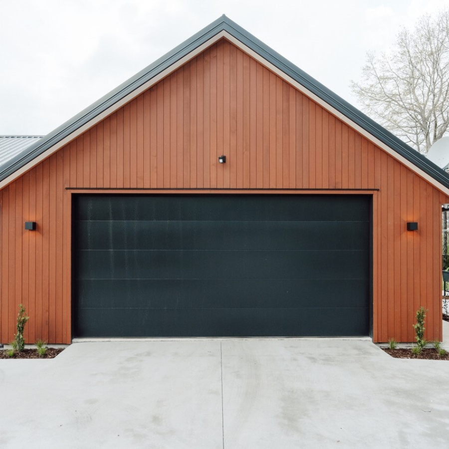 JSC's Alaskan Yellow Cedar vertical shiplap cladding coated in JSC Scumble Desert contrast against black cladding by Transform Construction